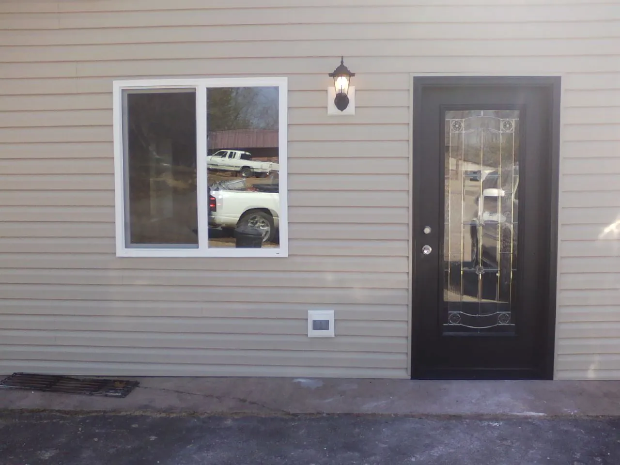 New siding, window and entry door on the side of an addition in Kenton